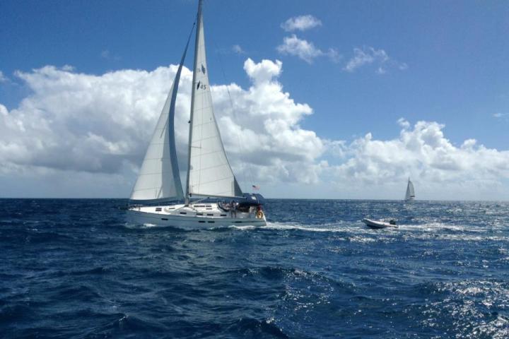 Sailboat Heading Downwind with Boat Behind It